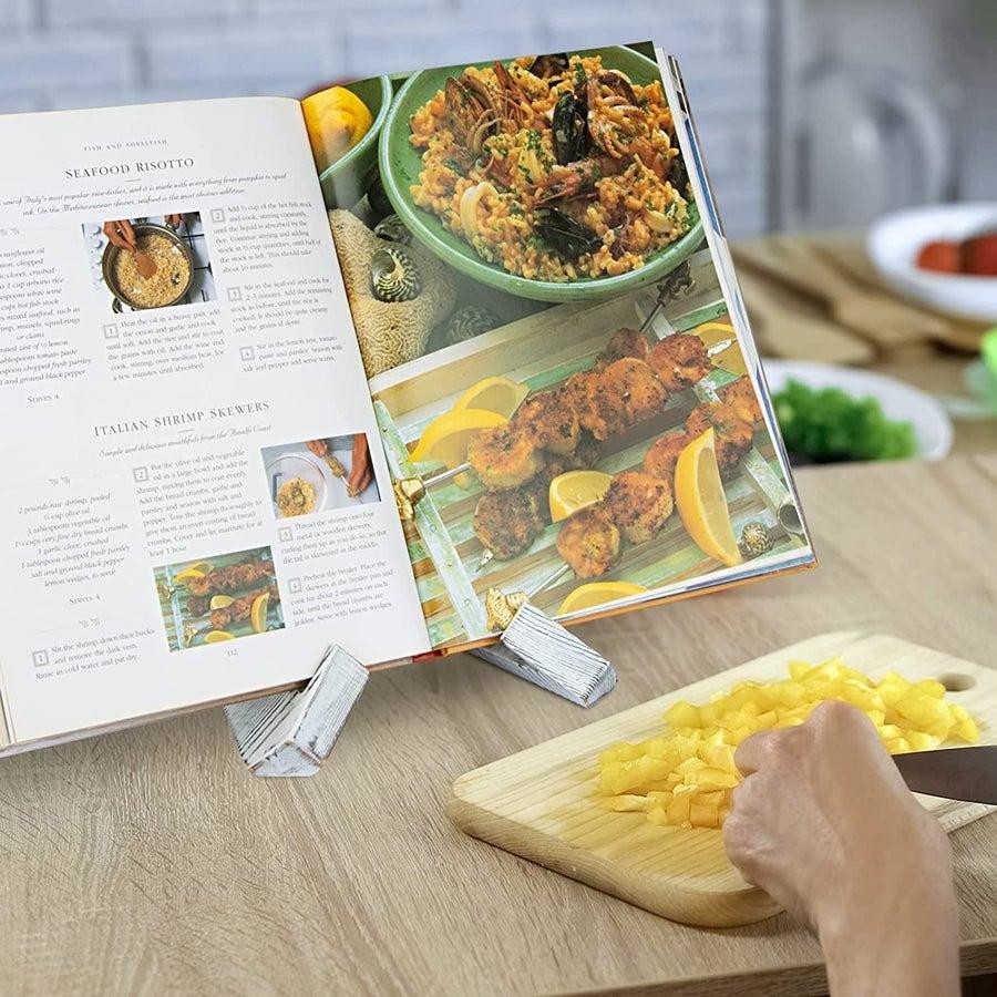 A recipe book open on a kitchen counter